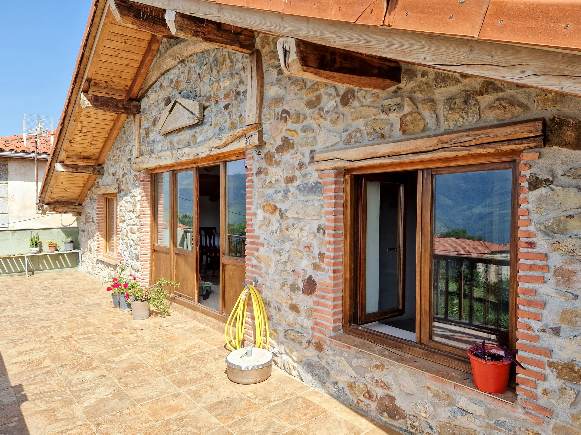 First-floor private terrace with panoramic mountain backdrop